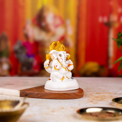 Golden and White Ganesh Statue with Stones