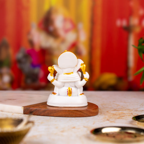 Golden and White Ganesh Statue with Stones