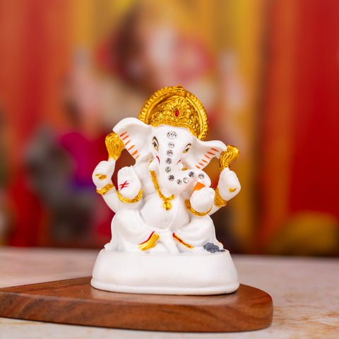 Golden and White Ganesh Statue with Stones